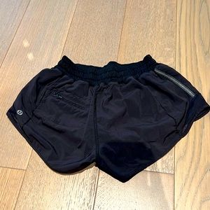 Black Lululemon running shorts with back zip pocket and waist tie